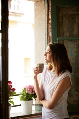 Coffee, thinking and woman by window with morning ideas, inspiration and daydreaming in home....