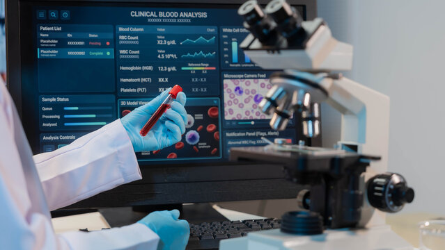 Medical lab technician conducting hematology research and checking test results on monitor
