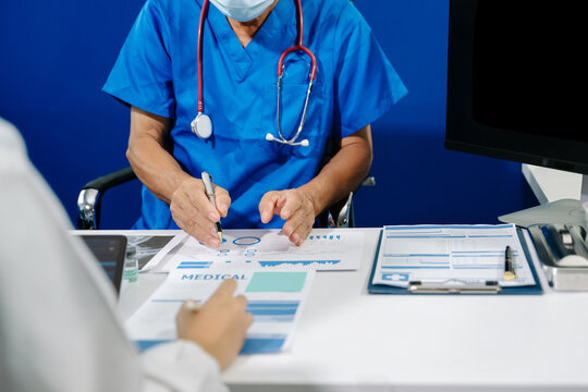 A dedicated medical team discusses patient diagnostics, reviewing brain MRIs and medical charts on digital devices
