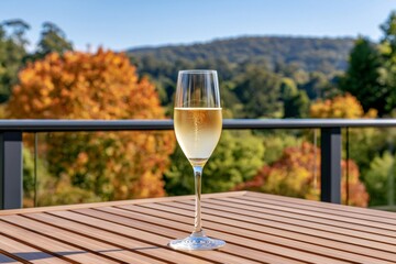 Naklejka premium Champagne flute with sparkling wine on outdoor autumn terrace