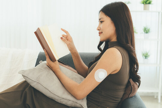 Woman Checking Blood Glucose Level During Telehealth Consultation at Home