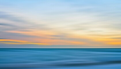 Fototapeta premium Abstract motion blur seascape with pastel sunset sky over calm ocean