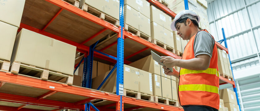 Asian male factory manager inspect goods in warehouse or inventory and check stock product. Transport logistic business shipping, delivery to customers. inspection, storehouse, storage, factory