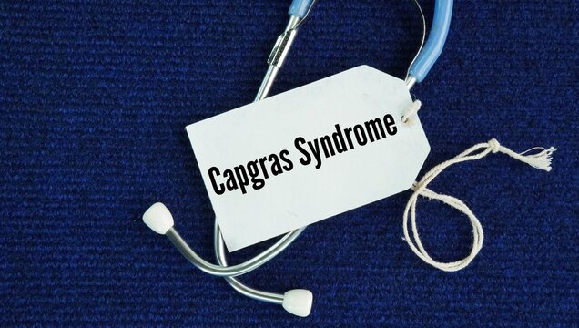 Stethoscope and paper tag with the word Capgras Syndrome. rare psychiatric disorder where a person believes that a friend, spouse, family member, or pet has been replaced by an identical impostor