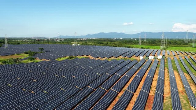 Neatly arranged solar photovoltaic panel arrays under blue sky
