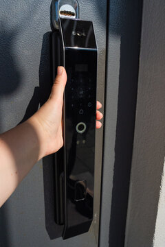 Gray door opening by hand on Black Modern Smart Lock