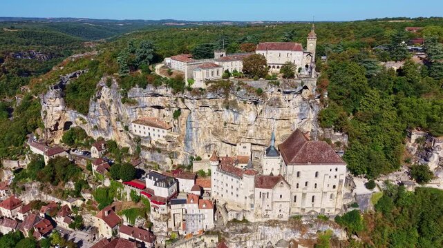 Drone advances toward Rocamadour sanctuary and layered buildings on the cliff