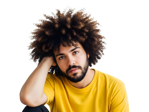 A contemplative young man with an afro hairstyle and yellow t-shirt posing