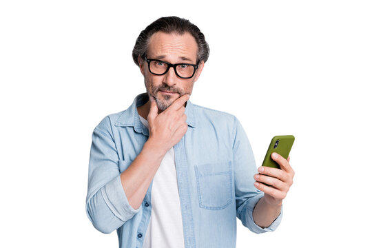 Photo of mature man think thoughtful use cellphone read browse post repost isolated over grey color background