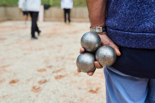 Senior Man Holding Metal Petanque Boules Behind Back Outdoor Game