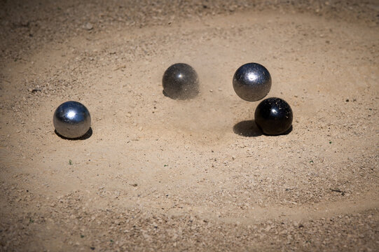 Petanque Metal Boule Hitting Ground with Dust Splash Outdoor Game Action