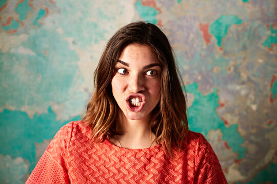 Character, woman and silly face on damaged wall for theater improvisation or acting class. Female person, student or hush with goofy expression on weathered or peeling background for school play