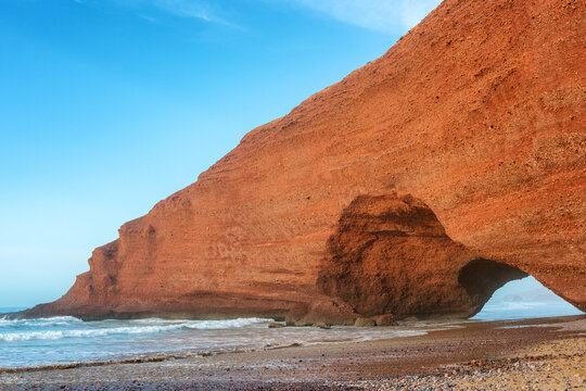 Dramatic red sandstone arch on Legzira Beach in Morocco