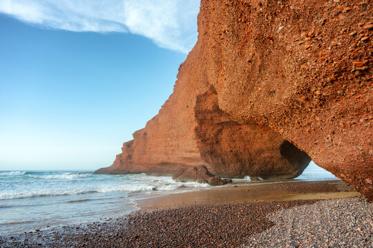 Beautiful red stone arch at Legzira Beach in Morocco