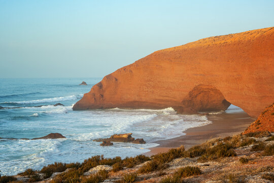 Red rock arch on Legzira Beach Morocco at sunset