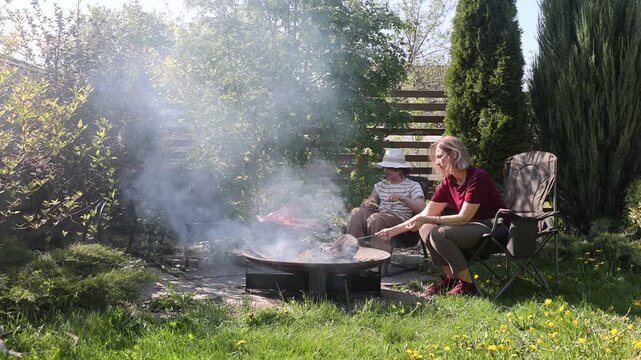 outside patio garden a Fire pit area with chairs. A cozy corner in a country house. an atmospheric relaxation area gatherings by the fire