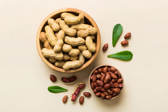 Fresh healthy peanuts in bowl on colored table background. Top view Healthy eating bertholletia concept. Super foods
