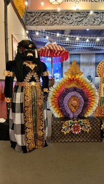 DENPASAR,BALI,INDONESIA,AUGUST 30,2026:Traditional Balinese Ogoh-Ogoh Statue in Black and Gold Costume with Colorful Floral Decoration
