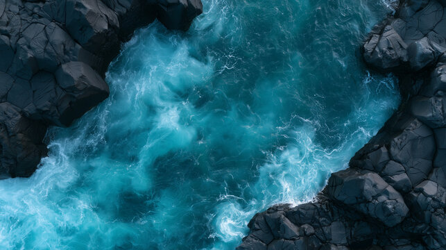 Aerial View of Rushing Turquoise Water Flowing Through Dark Volcanic Rock Formations in a Scenic Natural Landscape