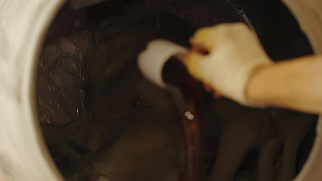 Worker mixing mortar in concrete mixer at construction site