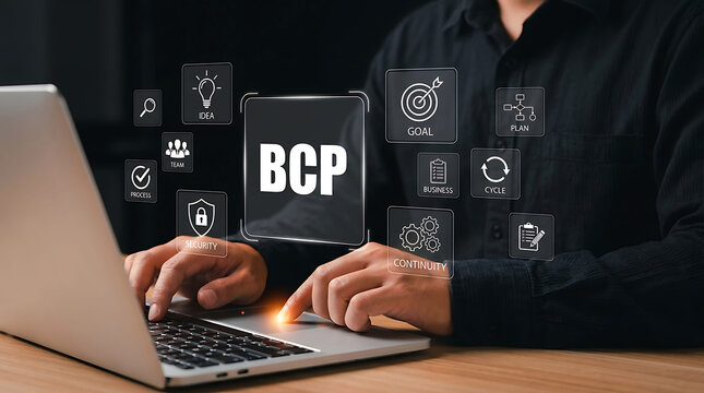 Professional working on laptop with virtual business continuity plan icons
