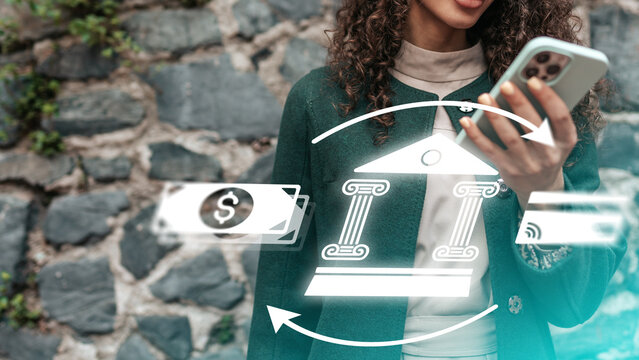 Online payment process with a person using a smartphone near a stone wall