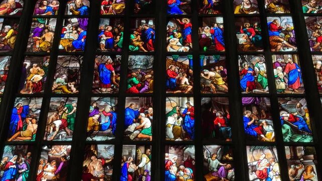 Milan, Italy - May 05, 2026: Gothic cathedral interior with towering columns, intricate arches, and illuminated stained glass windows showcasing architectural beauty