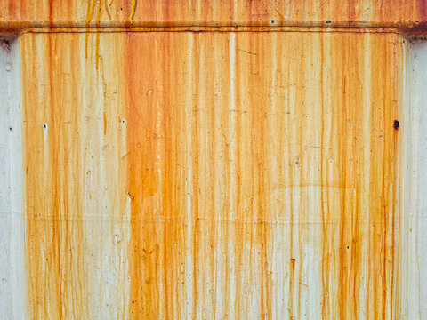 Dirty white wall background with dramatic vertical steel rust streaks and textured time deterioration patterns.