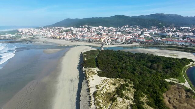Stunning aerial view over Vila Praia de &Acirc;ncora in northern Portugal, flying above the river, ocean and sandy beach along the Atlantic coast.
