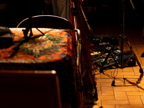 Guitar Effects Pedalboard and Vintage Chair on Stage Floor, Backstage Music Setup