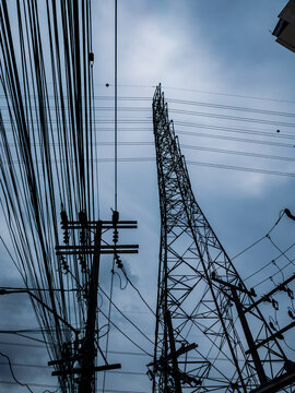 Electricity Transmission Tower and Power Lines Silhouette Against Evening Sky