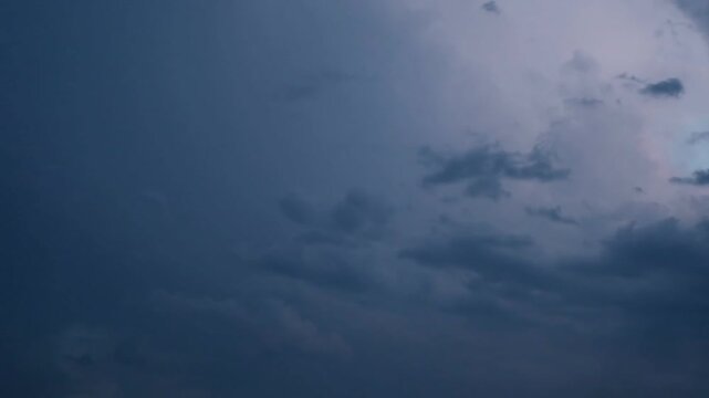 Beautiful intra cloud sheet lightning glowing inside purple and blue twilight clouds