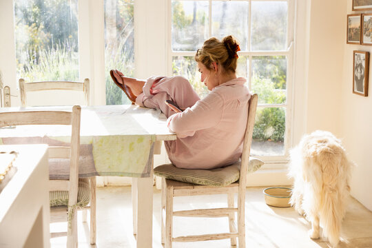 young woman relaxing in chair looking at her smart phone