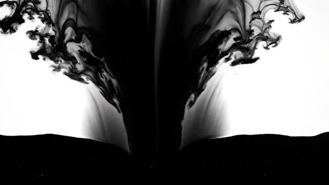 Black ink drop falling and dispersing in water in slow motion studio shot on white background