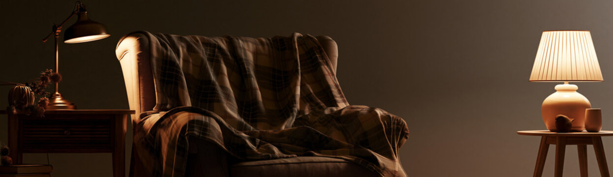 Cozy armchair with plaid blanket between two glowing table lamps in dark living room interior. Warm evening home comfort and hygge relaxation concept for interior design background.