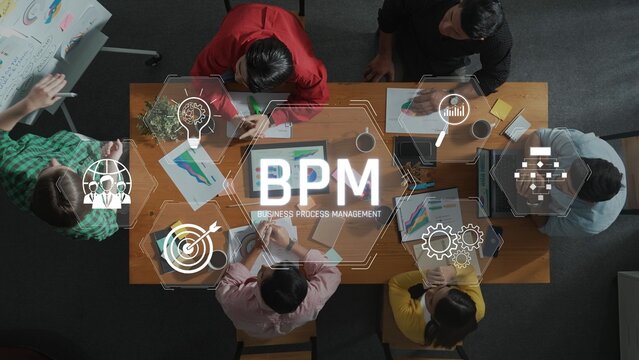 A dynamic team collaborates on business process management strategies, presenting charts and ideas in a modern workspace, fostering creativity and innovation. Raster
