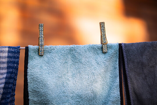 Laundry is drying on a clothesline outside on a sunny summer day.