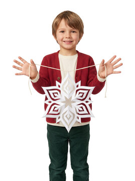 Young child presenting a handcrafted paper snowflake ornament on open palms, winter craft moment with precise detail, on transparent background