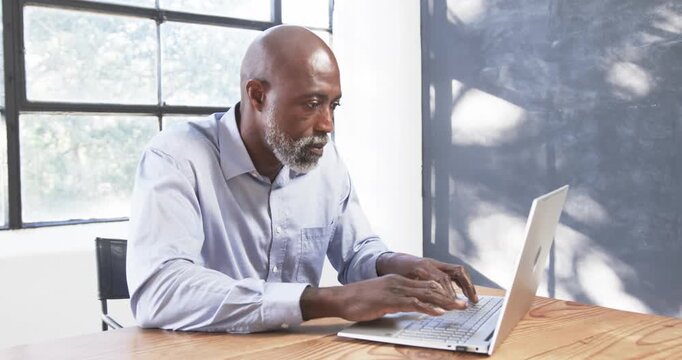 Lifestyle videos indoor of people doing activities at office, typing on laptop, man working at desk