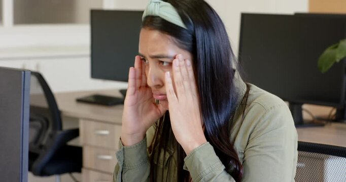 Lifestyle videos indoor of people doing activities at office, stressed woman in office rubbing her f