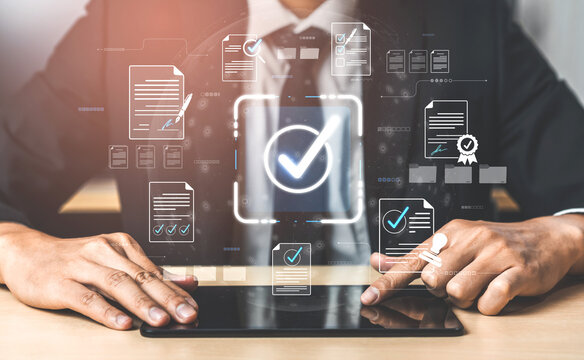 Businessperson Using Tablet with Digital Checkmarks, Certification Icons, and Document Management Interface for Quality Assurance in Modern Office Environment Sigmoid