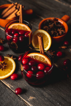 Mulled wine with ingredients on rustic wooden background. Selective focus.
