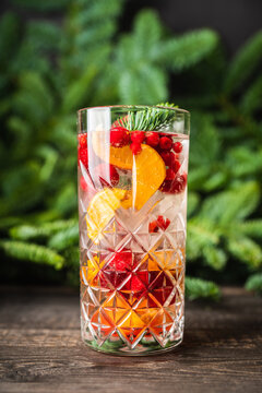 Christmas mojito cocktail with mandarins cranberry and lingonberries. Christmas style cocktails. Selective focus.