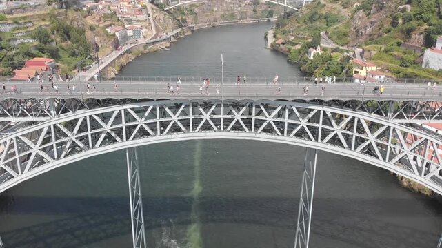 Aerial, drone shot descending from the upper deck to the lower deck of Dom Luis I Bridge, Porto, Portugal