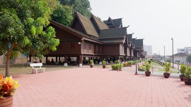 Elevating 4K slow-motion shot revealing the side exterior of the traditional wooden Melaka Sultanate Palace Museum in Melaka, Malaysia.