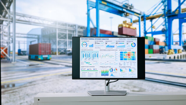 Computer monitor logistics data dashboards in a container terminal, with cargo cranes and stacked shipping containers blurred in the background.