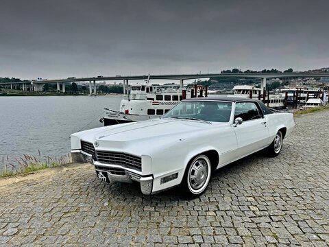 White Cadillac Eldorado vintage car by river in Porto