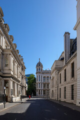 Obraz premium London - 07 24 2022: Carey Street historic stone façades with domed tower and red post box