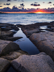 Fototapeta premium Coastal scenery at sunset along the rocks of Vallda Sandö in Halland, Sweden