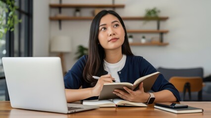 Fototapeta premium Woman working on laptop at home office desk